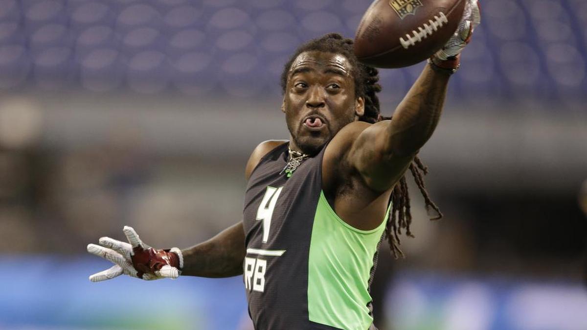 Arkansas running back Alex Collins runs a drill at the NFL football scouting combine in February.