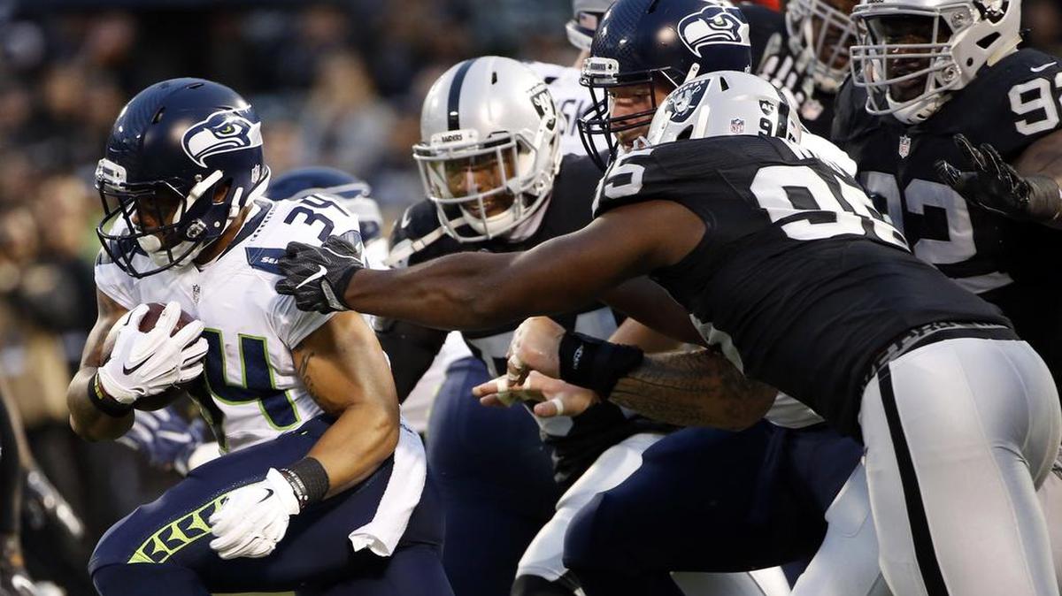 Seattle Seahawks running back Thomas Rawls (34) runs against the Raiders during the first half of a preseason game Thursday in Oakland, Calif.
