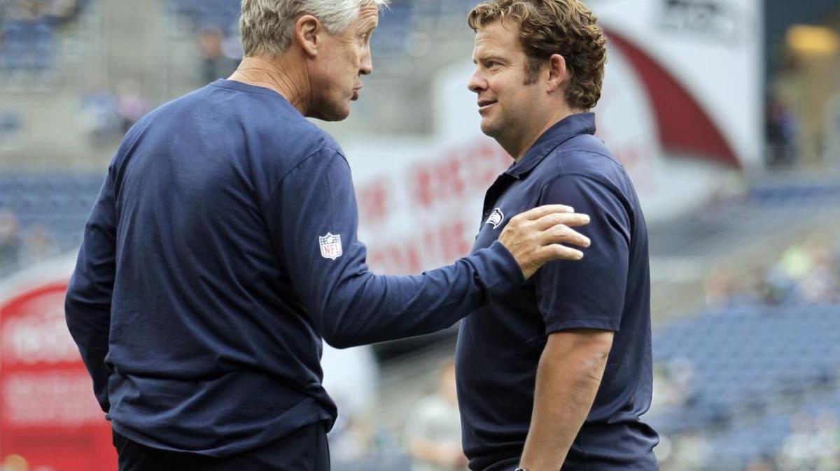 Seattle Seahawks head coach Pete Carroll, left, and general manager John Schneider, right, made their biggest moves of the year’s NFL free agency by keeping quarterback Russell Wilson and linebacker Bobby Wagner out of it.