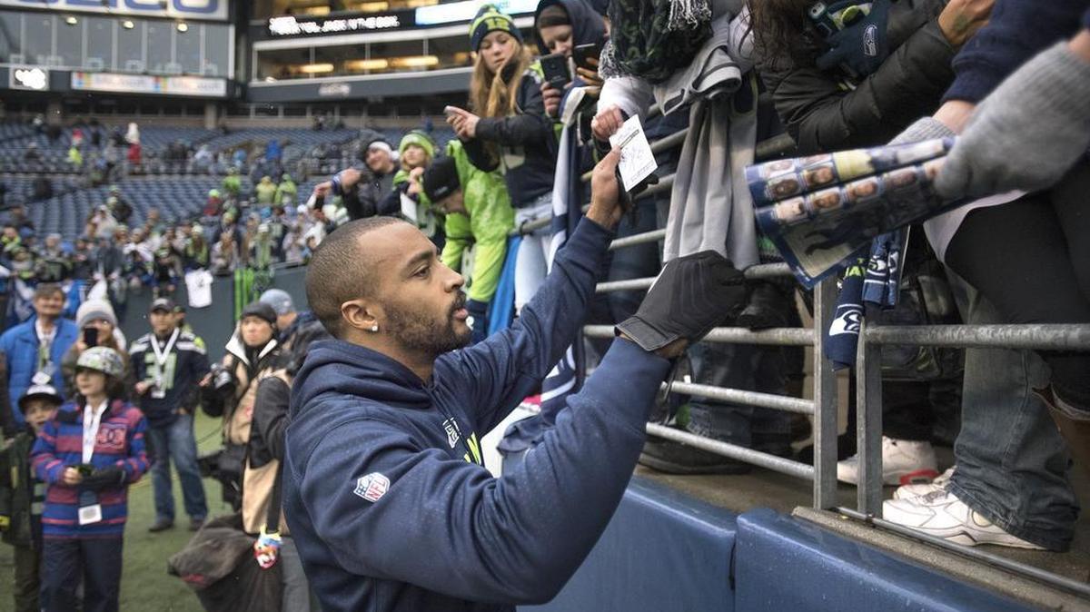 Seahawks wide receiver Doug Baldwin signs autographs for fans before Sunday's NFL football game against the St. Louis Rams at CenturyLink Field in Seattle on Dec. 27, 2015.