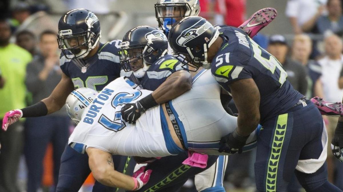 
Lions fullback Michael Burton is tossed around by Seahawks defenders (from left) Cary Williams, Bobby Wagner and Bruce Irvin during the Monday Night Football game at CenturyLink Field in Seattle on Oct. 5, 2015. 
