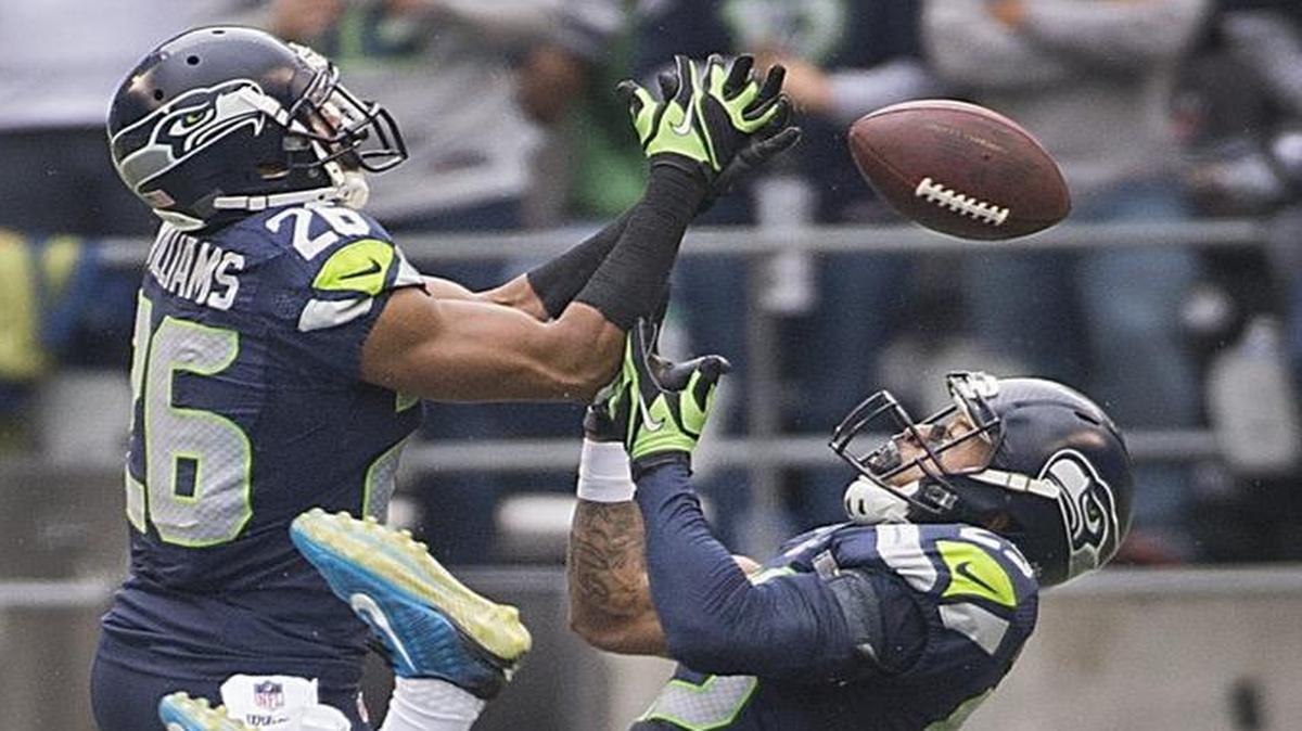 
Seahawks defenders Earl Thomas, right, and Cary Williams break up a long pass intended for Panthers receiver Devin Funchess in the second quarter Sunday.
