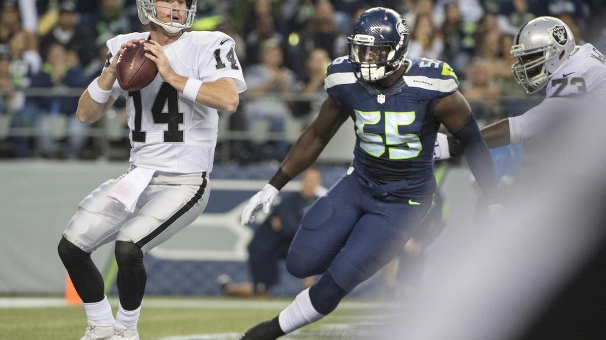 
Seahawks defensive lineman Frank Clark closes in on Raiders quarterback Matt McGloin in the end zone Thursday. Clark forced a fumble that was recovered by Jordan Hill for a Seahawks touchdown.
