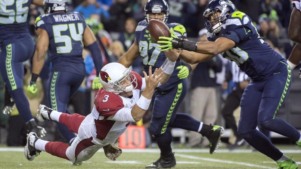 Seahawks linebacker K.J. Wright snags a fumble by Cardinals quarterback Carson Palmer (3) during Sunday night's NFL football game at CenturyLink Field in Seattle on Nov. 15, 2015.