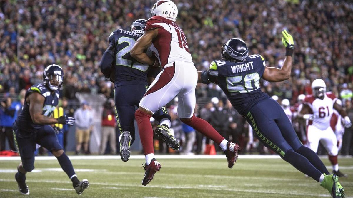 Seahawks safety Earl Thomas intercepts a pass at the goal line in front of Arizona Cardinals wide receiver Michael Floyd during Sunday night's NFL football game at CenturyLink Field in Seattle on Nov. 15, 2015.