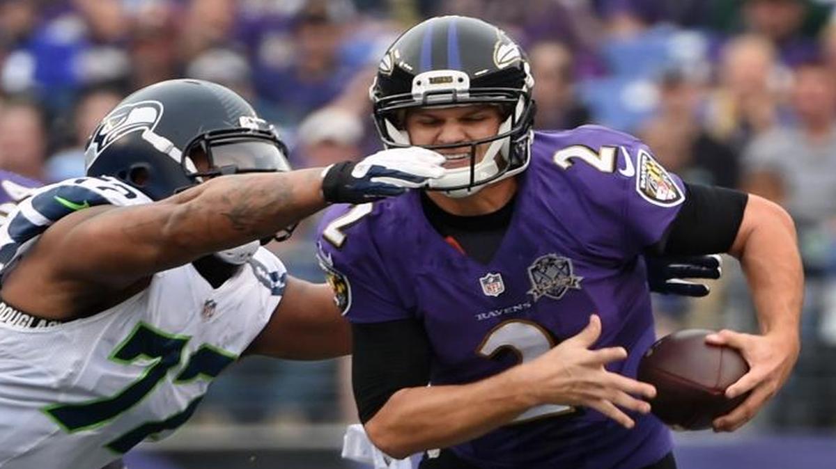 Seattle’s Michael Bennett closes in on Baltimore quarterback Jimmy Clausen in the first quarter. Bennett finished with four tackles, three solo, one sack and one tackle for loss.