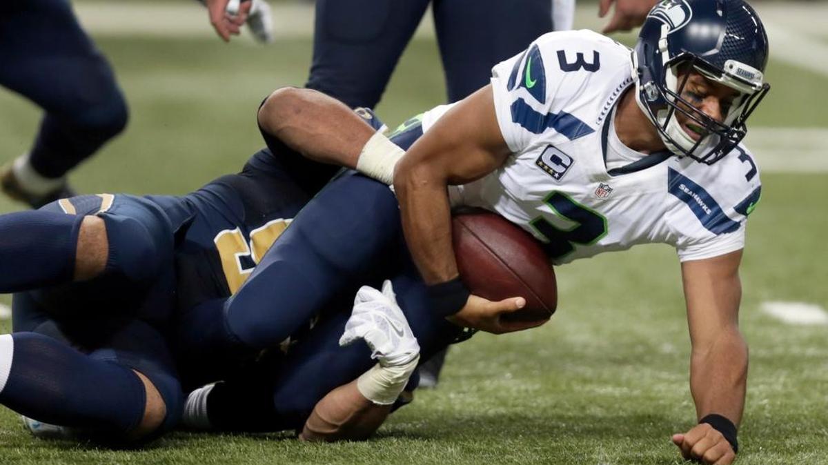 
Seattle Seahawks quarterback Russell Wilson, right, is sacked for a 4-yard loss by St. Louis Rams defensive tackle Aaron Donald during the third quarter of an NFL football game Sunday, Sept. 13, 2015, in St. Louis.
