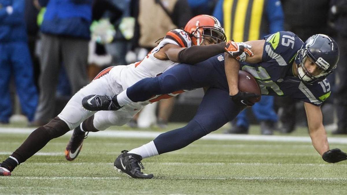 Seahawks receiver Jermaine Kearse is brought down after making a catch against Cleveland. Photo taken in Seattle on Sunday, Dec. 20, 2015.