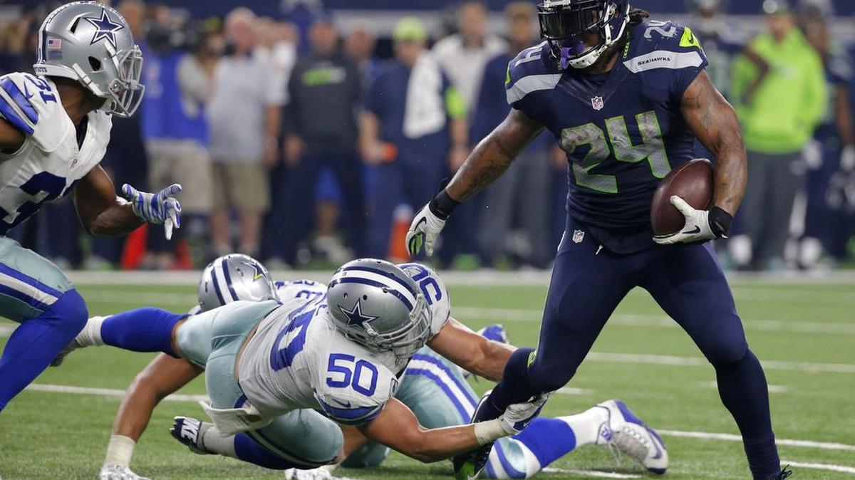 Seattle Seahawks running back Marshawn Lynch (24) breaks through a tackle-attempt by Dallas Cowboys' Sean Lee (50) as Cowboys Byron Jones, left, comes over to help on the running play in the second half of a Nov. 1 NFL game, in Arlington, Texas.