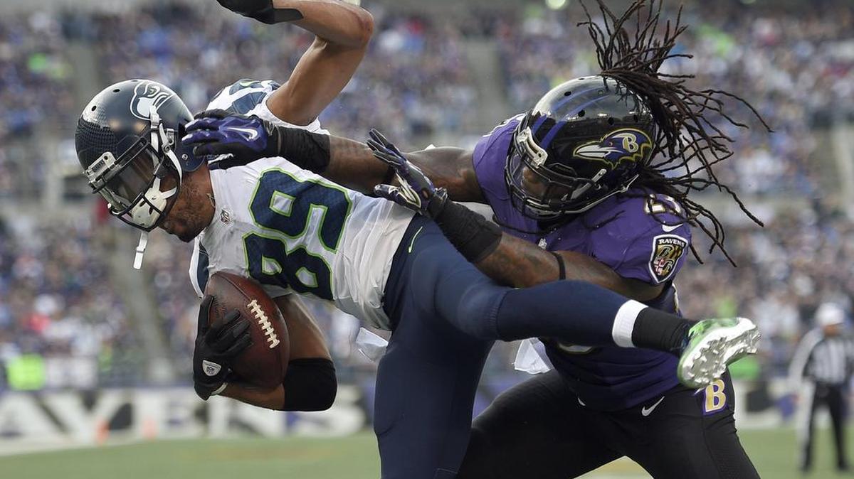 Seahawks wide receiver Doug Baldwin (89) is hit by Ravens free safety Kendrick Lewis as Baldwin scores a touchdown Sunday.