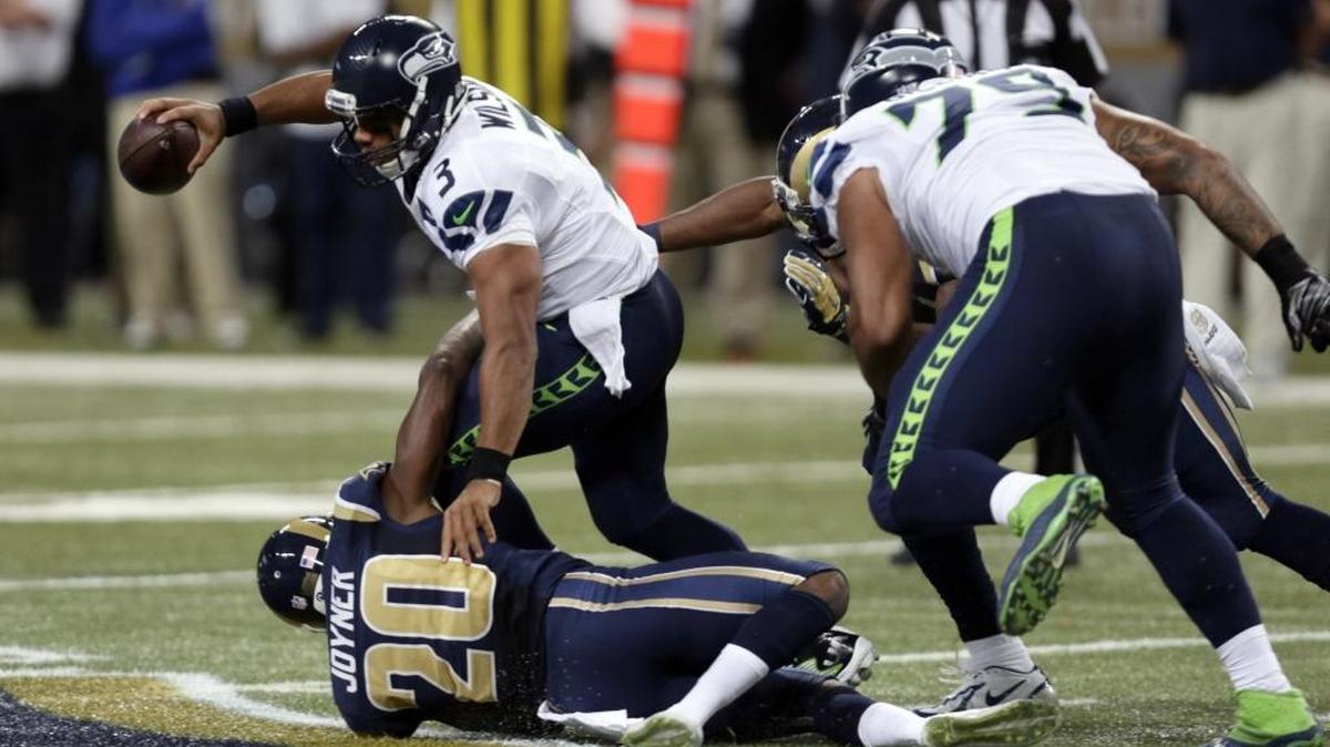 
Seahawks quarterback Russell Wilson is sacked Sunday in St. Louis as offensive lineman Garry Gilliam is beaten. Wilson was sacked six times in the loss.
