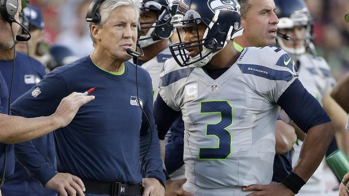 Seattle Seahawks head coach Pete Carroll stands next to quarterback Russell Wilson (3) during the first half of an NFL football game against the San Francisco 49ers in Santa Clara, Calif., Thursday, Oct. 22, 2015.