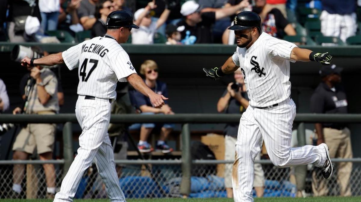 
Chicago White Sox's Melky Cabrera, right, celebrates with third base coach Joe McEwing after hitting a solo home run against the Seattle Mariners during the seventh inning of a baseball game Sunday, Aug. 30, 2015, in Chicago.

