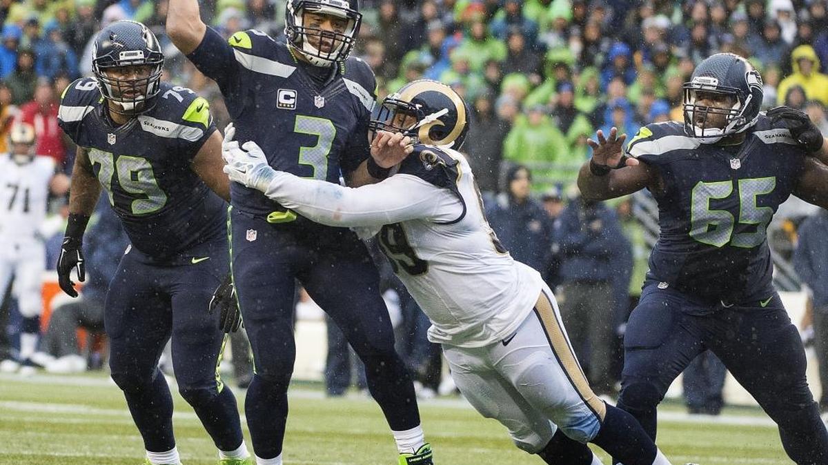 Seattle quarterback Russell Wilson is nearly sacked by Rams tackle Aaron Donald in the first half. Photo taken in Seattle on Sunday, Dec. 27, 2015.