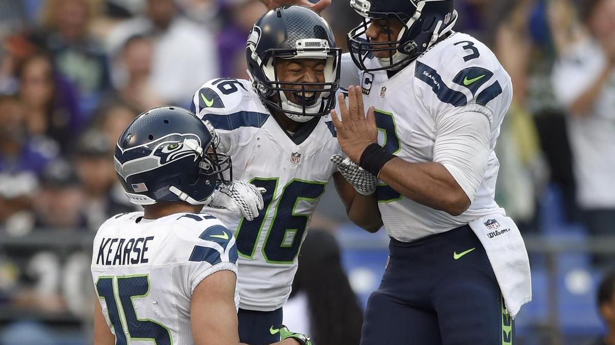 Seattle Seahawks wide receiver Jermaine Kearse (15) watches as Seahawks wide receiver Tyler Lockett (16) and Seahawks quarterback Russell Wilson (3) celebrate connecting for a touchdown during the second half an NFL football game against the Baltimore Ravens, Sunday, Dec. 13, 2015, in Baltimore.