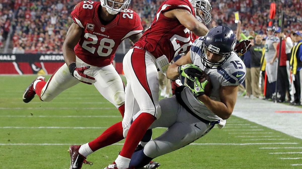 Seattle Seahawks wide receiver Jermaine Kearse (15) falls into the end zone for a touchdown as Arizona Cardinals free safety Rashad Johnson (26) and cornerback Justin Bethel (28) defend during the first half of an NFL football game, Sunday, Jan. 3, 2016, in Glendale, Ariz. (AP Photo/Ross D. Franklin)