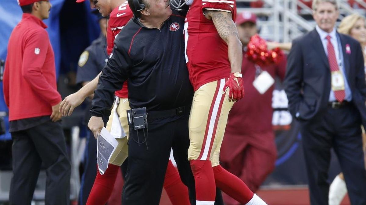 San Francisco 49ers head coach Jim Tomsula congratulates quarterback quarterback Colin Kaepernick on his 76-yard touchdown throw against the Baltimore Ravens in the second quarter Sunday.