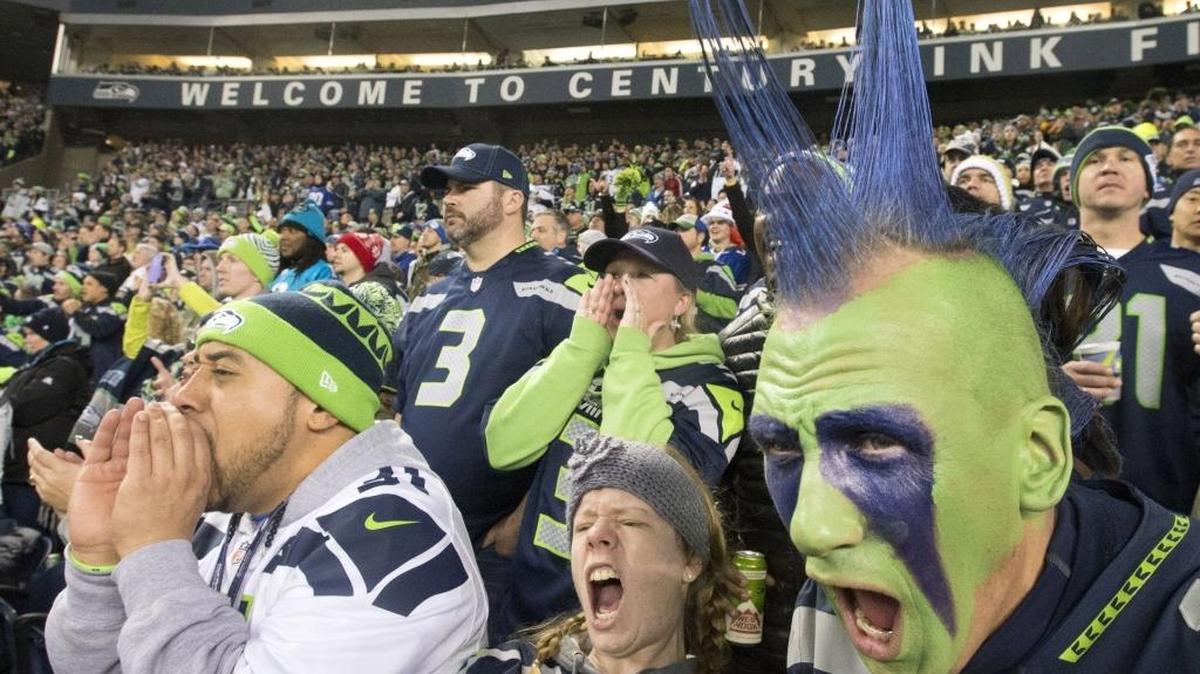 
Seahawks fans such as Justin Pelesasa, left, of Tacoma, Elisabeth Britton, formerly of Puyallup, and Phil Andruss of Tacoma, help give their favorite team a decided home-field advantage at CenturyLink Field.

