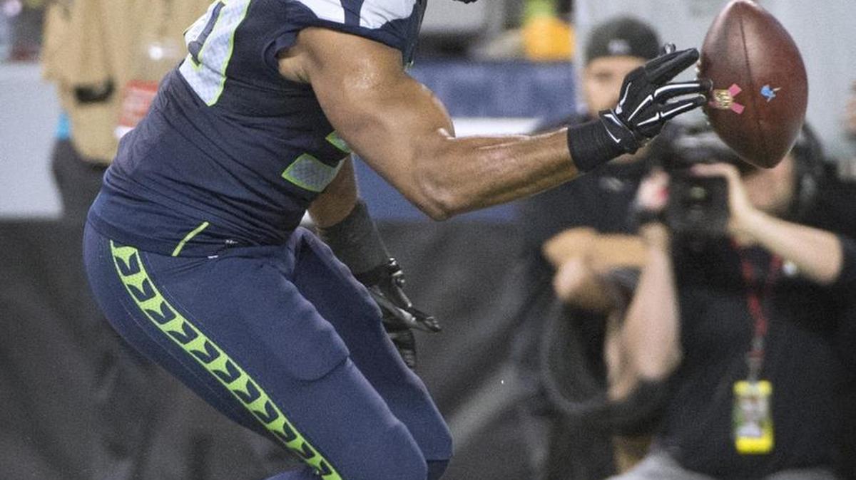 
Seahawks linebacker K.J. Wright reaches for Calvin Johnson’s fumble before the ball went out of the back of the end zone. Some think that an illegal batting penalty should have been called. 
