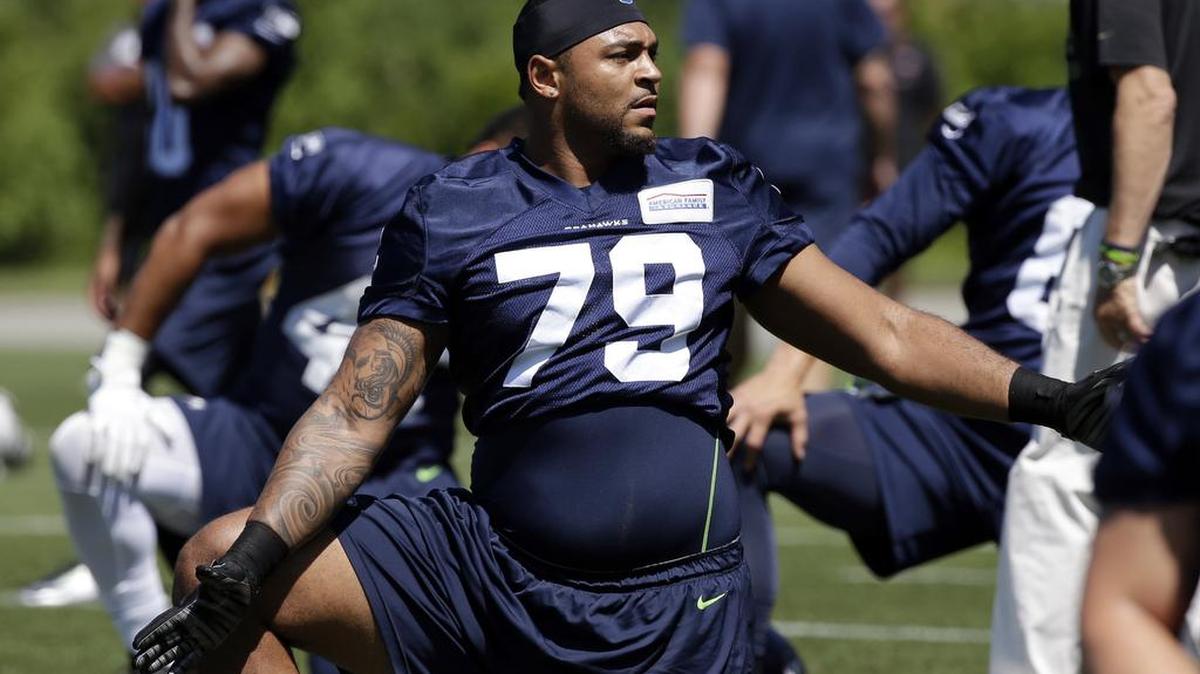 Seattle Seahawks' Garry Gilliam stretches during an NFL football organized team activity Tuesday, June 9, 2015, in Renton.