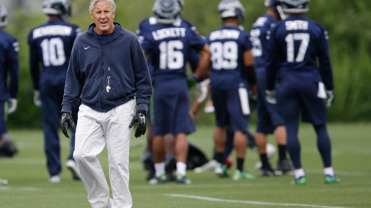 Seattle Seahawks coach Pete Carroll walks on the field during NFL football practice, Thursday, June 9, 2016, in Renton.