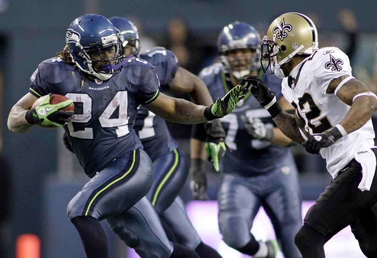 Seattle’s Marshawn Lynch (24) breaks away from the tackle of New Orleans Saints' Tracy Porter to score a touchdown in the second half of an NFC wild card playoff football game, Saturday, Jan. 8, 2011.