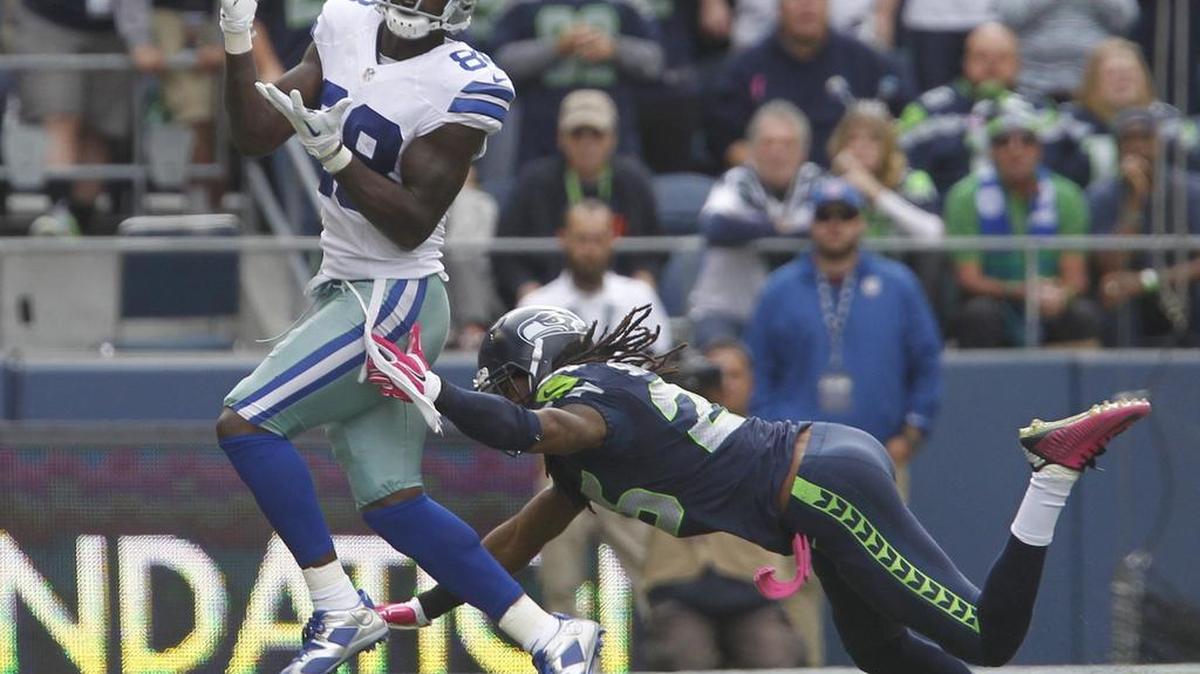 Dallas wide receiver Dez Bryant pulls in a pass over Seattle corner Richard Sherman last season at CenturyLink Field. Sherman allowed just two of Bryant’s four catches in the game and may be matched up against him again Sunday.