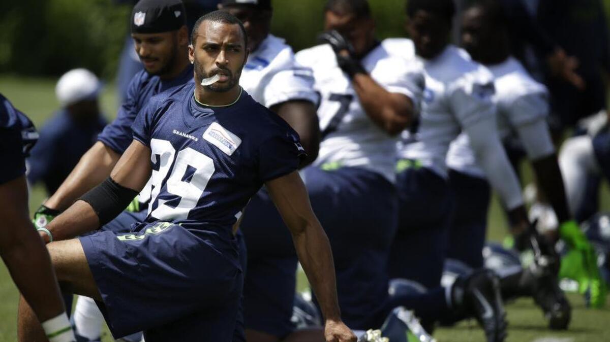 Seattle Seahawks wide receiver Doug Baldwin, left, stretches with teammates during NFL football practice, Wednesday, June 15, 2016, in Renton, Wash.