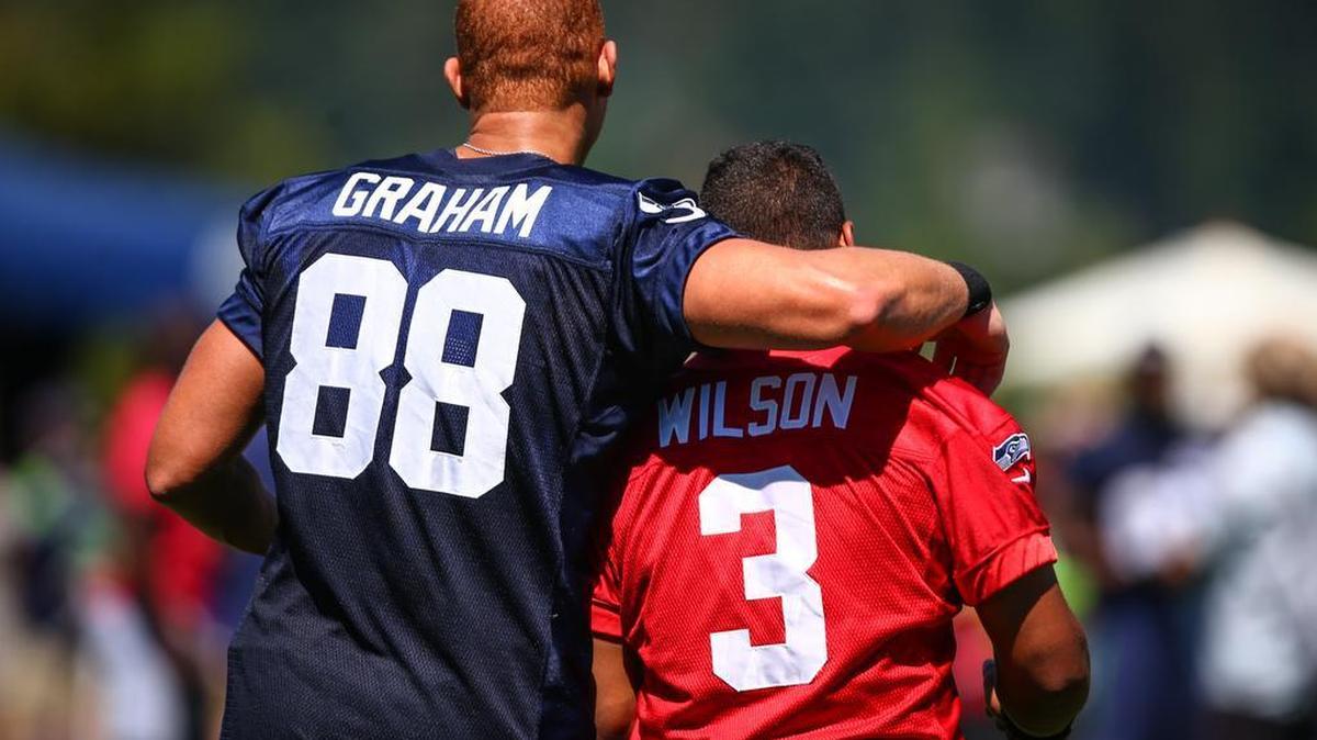 
Seattle Seahawks' Jimmy Graham and Russell Wilson walk off the field after the first day of NFL football training camp at the Virginia Mason Athletic Facility in Renton, Wa., Friday, July 31, 2015. 
