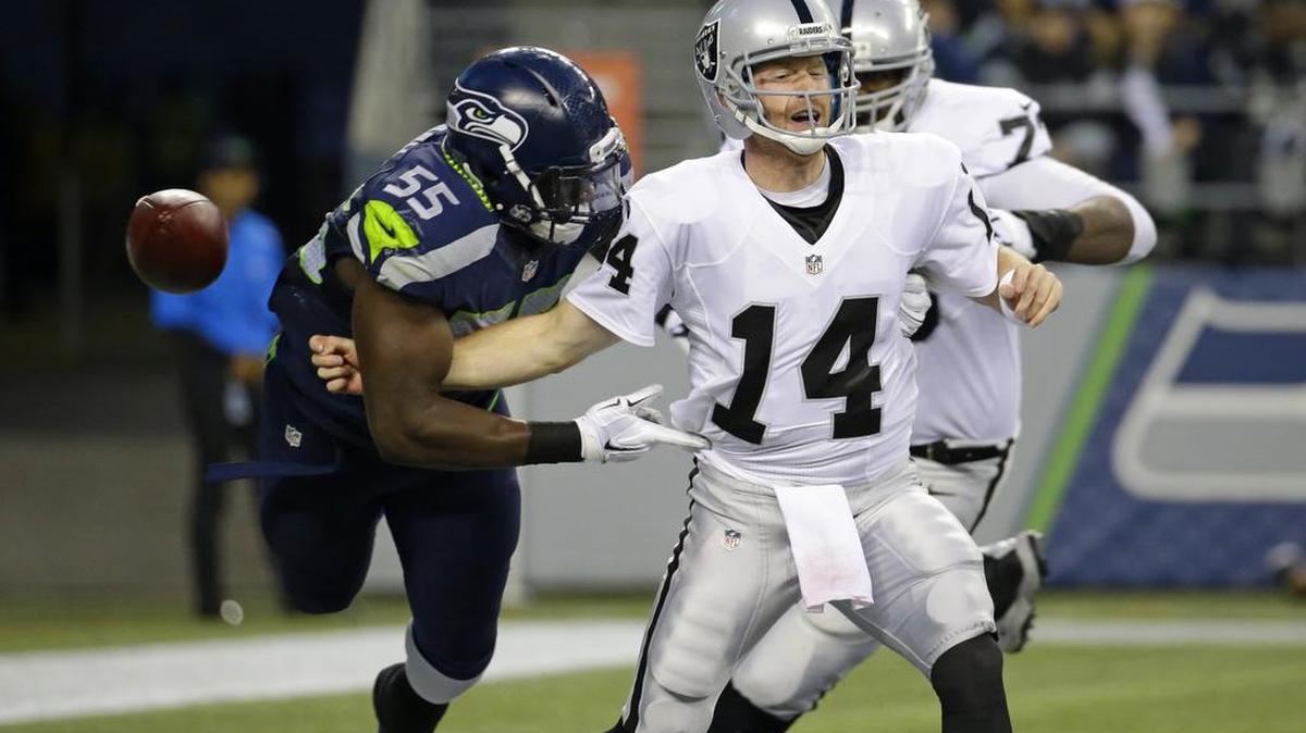 
Seahawks rookie Frank Clark (55) causes Oakland quarterback Matt McGloin to fumble in the final exhibition game Sept. 3.

