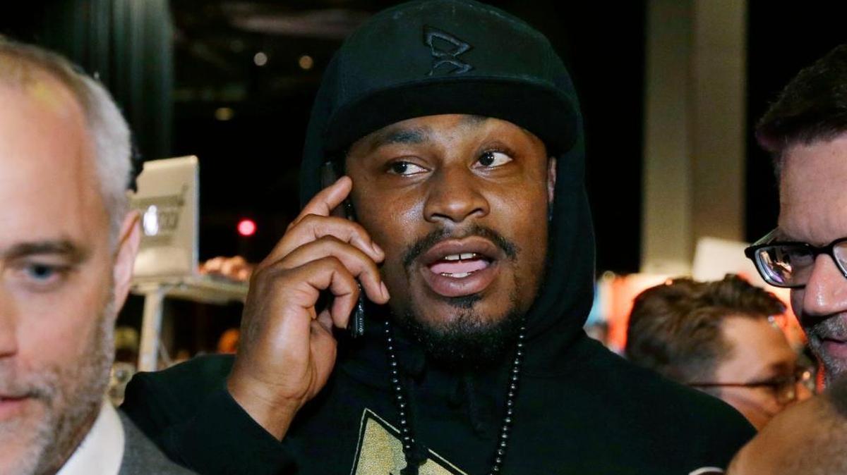 Marshawn Lynch, a former NFL football running back with the Seattle Seahawks, talks on the phone after giving a speech, Thursday, May 5, 2016, at a job fair in Seattle sponsored by the 100,000 Opportunities Initiative, an organization backed by Starbucks and other companies that seeks to increase employment and education opportunities for youth aged 16-24. The Seahawks announced Thursday that Lynch has been placed on the reserve/retired list.