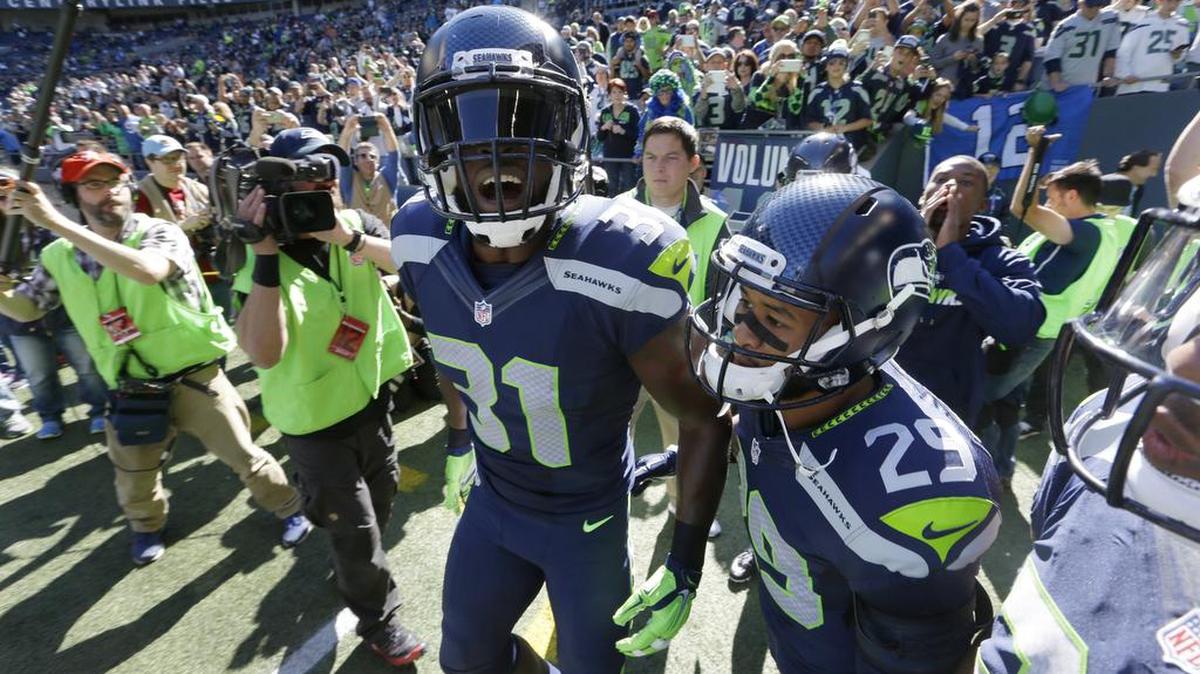 
Seahawks strong safety Kam Chancellor (31) and free safety Earl Thomas (29) take the field before Seattle’s home game against Chicago last Sunday.
