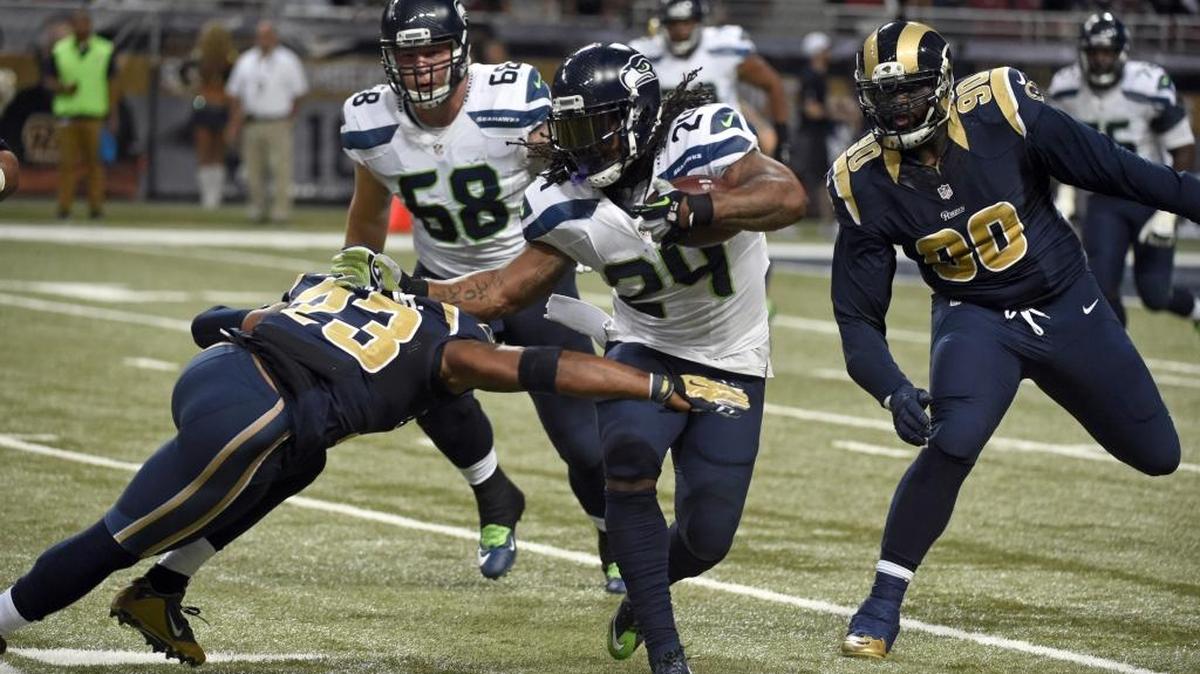 
Seattle Seahawks running back Marshawn Lynch (24) runs with the ball as St. Louis Rams free safety Rodney McLeod (23) and defensive tackle Michael Brockers (90) defend on Sunday, Sept. 13, in St. Louis. 
