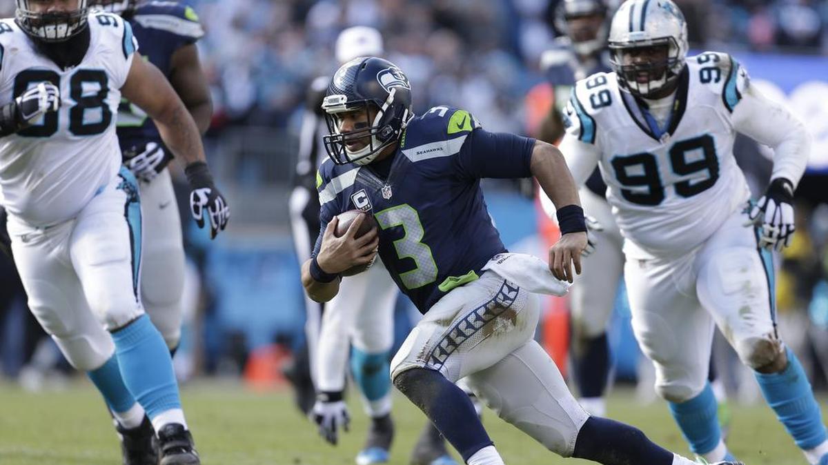 Seattle’s Russell Wilson runs the ball against Carolina. On Dec. 4, the teams will meet for the seventh time in five years.