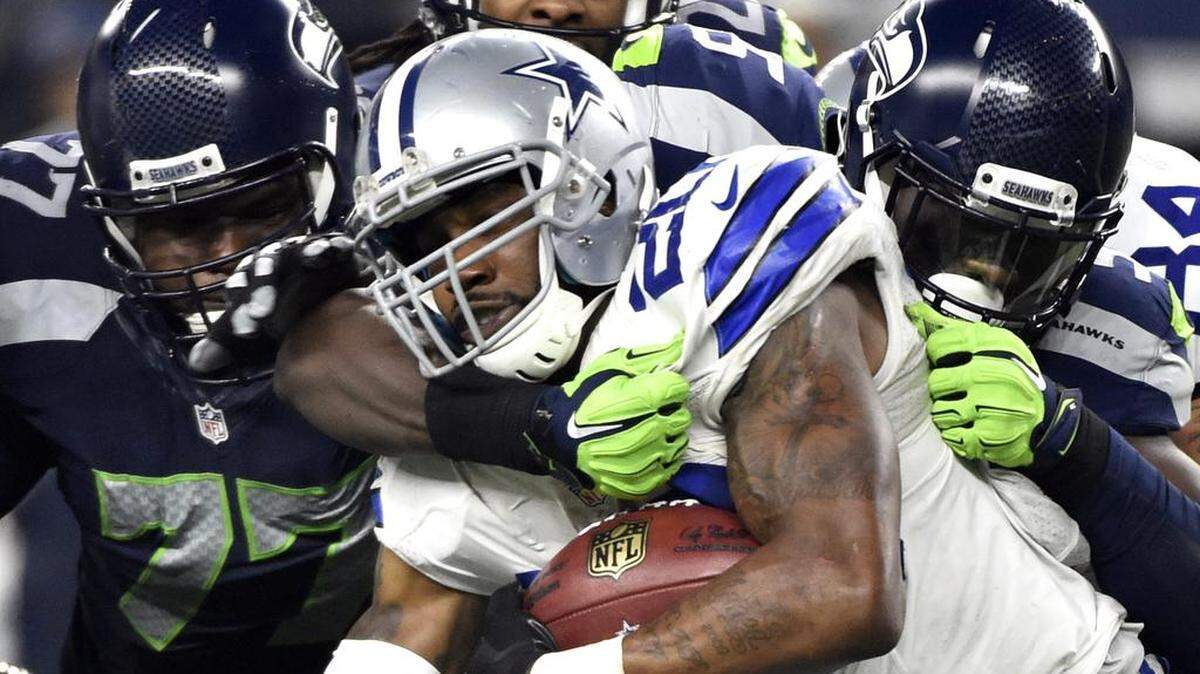 Seattle Seahawks' Ahtyba Rubin (77) and Frank Clark, right, combine to stop Dallas Cowboys’ Darren McFadden (20) on a running play in the second half of an NFL football game Sunday, Nov. 1, 2015, in Arlington, Texas.