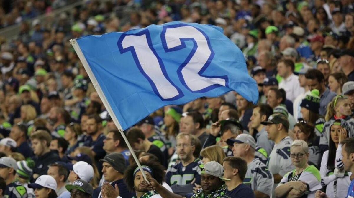A fan waves a Seattle Seahawks 12th Man flag in the second half of an NFL football game against the Detroit Lions, Monday, Oct. 5, 2015, in Seattle.
