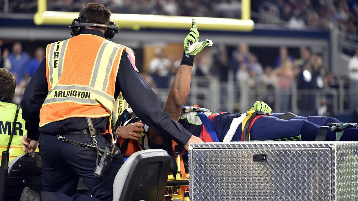 Seattle Seahawks’ Ricardo Lockette signals to cheering fans as he is carted off the field during Sunday’s game against the Dallas Cowboys. The Hawks announced Monday that Lockette will undergo surgery to repair a ligament in his neck.