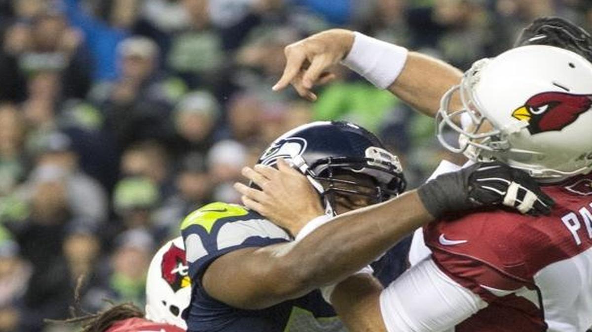 Seahawks defensive lineman Cliff Avril hits Cardinals quarterback Carson Palmer during Sunday night's NFL football game at CenturyLink Field in Seattle on Nov. 15, 2015.