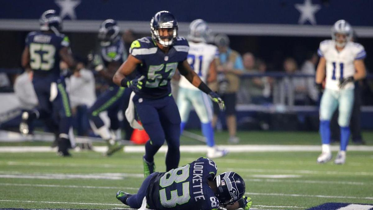 Seattle Seahawks' Mike Morgan (57) looks down at wide receiver Ricardo Lockette (83) who lays on the ground after suffering an injury in the first half of an NFL football game against the Dallas Cowboys Sunday, Nov. 1, 2015, in Arlington, Texas.