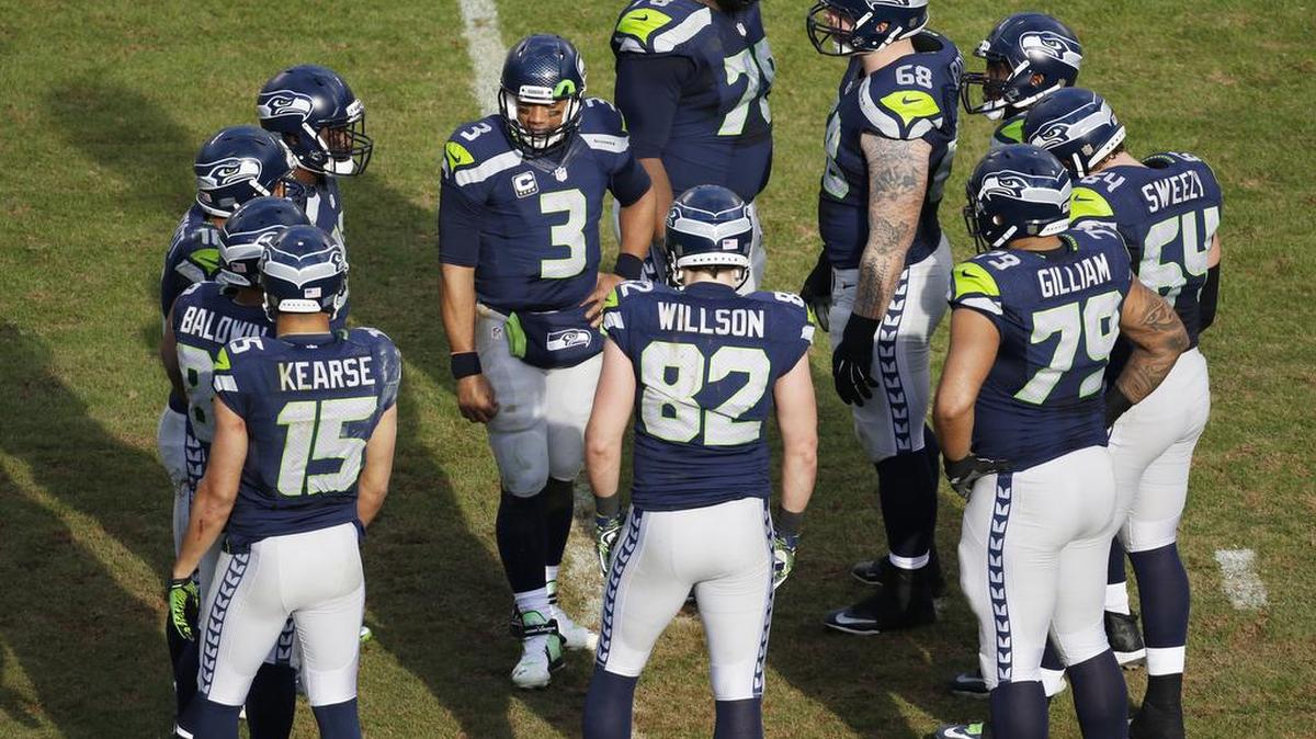 The Seattle Seahawks’ offense huddles during the second half Sunday under the leadership of quarterback Russell Wilson (3) against the Carolina Panthers on Sunday.