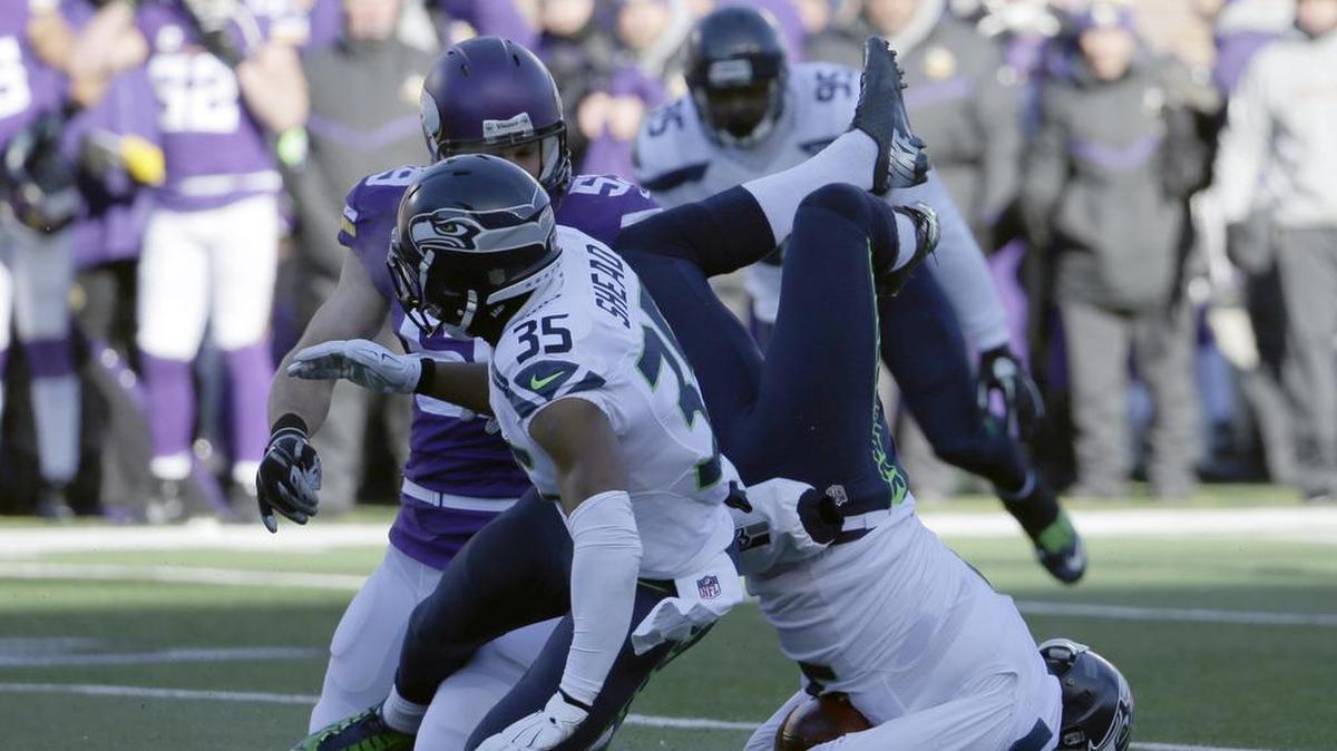 Seattle punter Jon Ryan (9) broke his nose Sunday when he landed on his face after attempting to vault a Minnesota defender. A bad snap forced him to try and run for the first down.