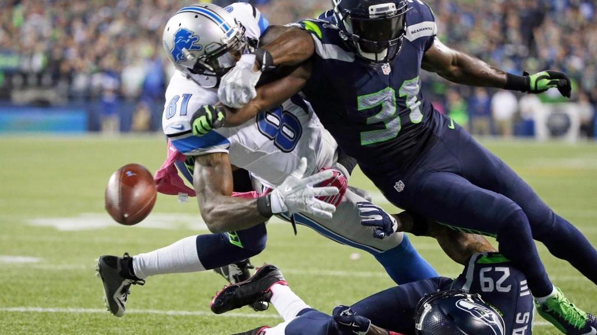 
Seattle strong safety Kam Chancellor (31) knocks the ball loose from Detroit wide receiver Calvin Johnson (81) in the second half Monday, Oct. 5, in Seattle. The fumble went out of bounds in the end zone and was ruled a touchback. The Seahawks beat the Lions 13-10. 
