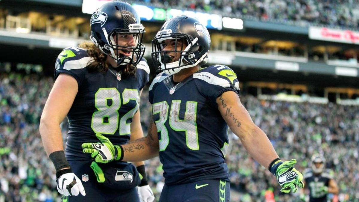 Seattle Seahawks running back Thomas Rawls (34) celebrates with teammate tight end Luke Willson (82) on Sunday, Nov. 22, in Seattle.