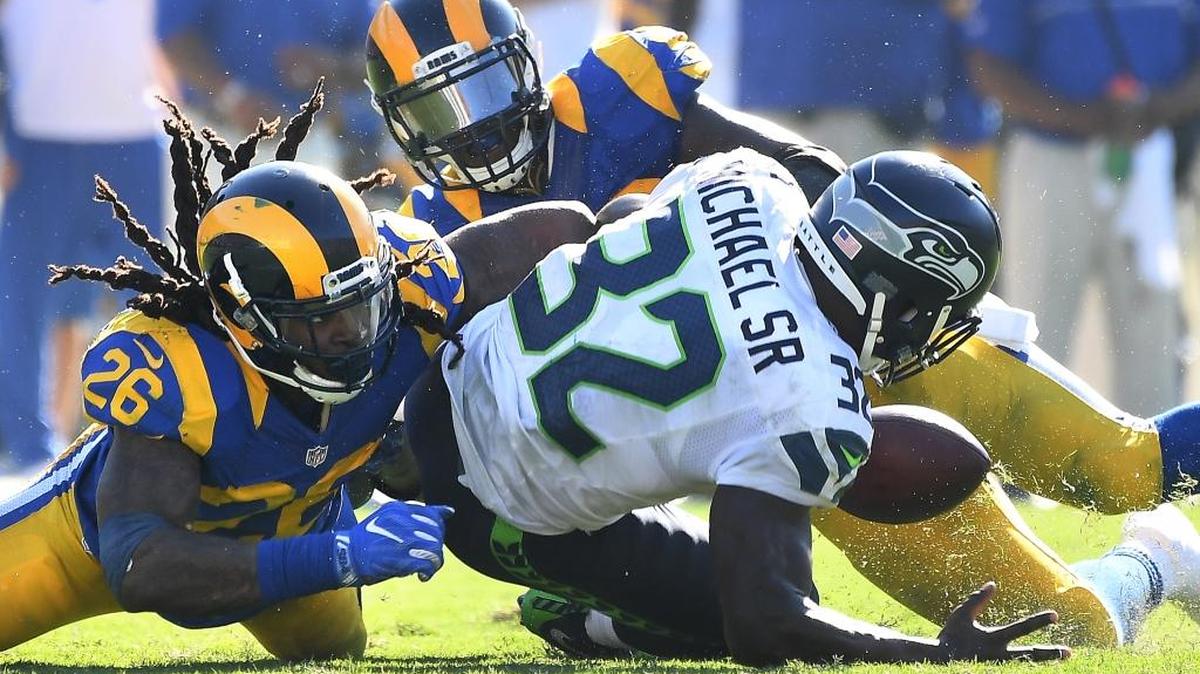 Los Angeles Rams' Mark Barron (26) causes a fumble as Alec Ogletree recovers the ball from Seattle Seahawks running back Christine Michael late in the fourth quarter on Sunday, Sept. 18, 2016 at the Los Angeles Memorial Coliseum in Los Angeles, Calif.