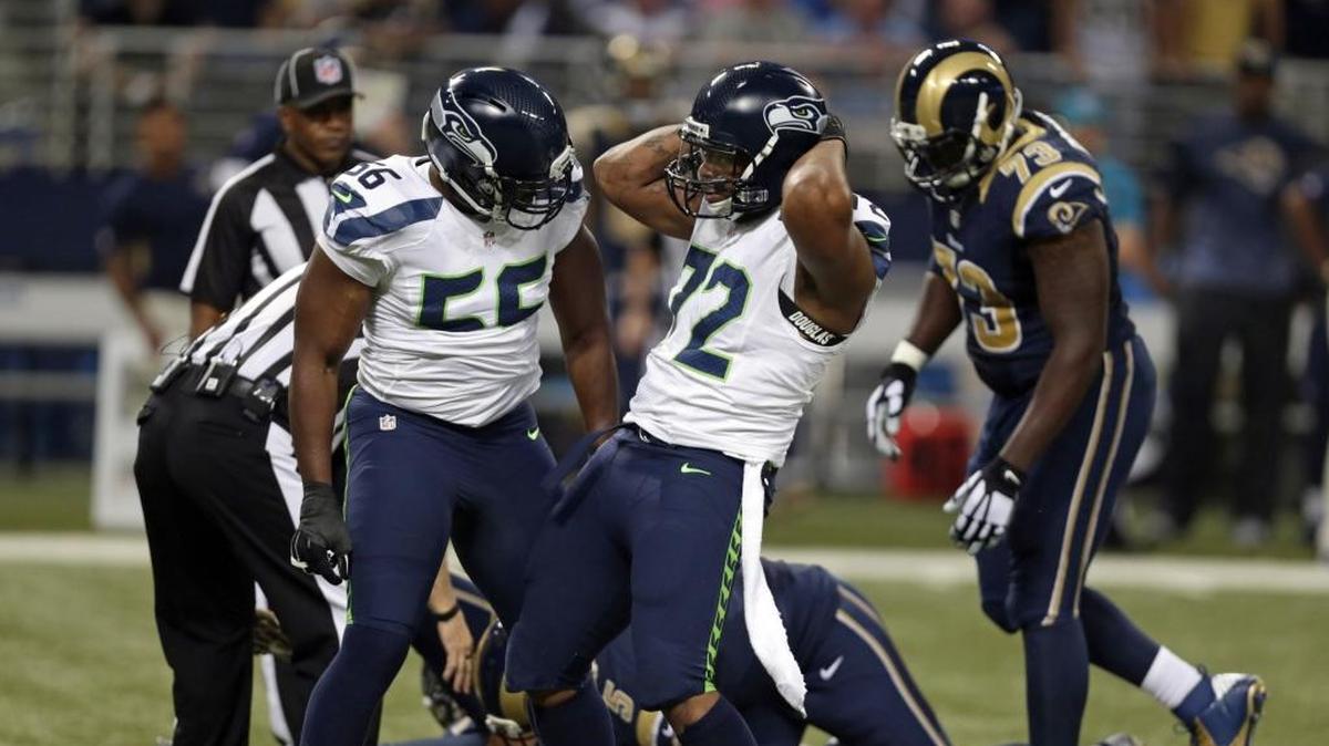 
Despite being unhappy with his contract, Seattle Seahawks defensive end Michael Bennett, right, was a disruptive force in the season opener against the Rams in St. Louis.
