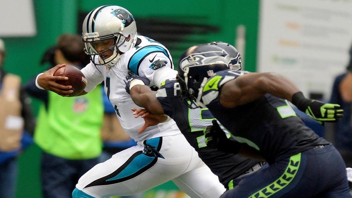 Carolina Panthers' Cam Newton (1) makes his way past Seattle Seahawks' Kevin Pierre-Louis (58) the first half at CenturyLink Field on Sunday, October 18, 2015. The Panthers won, 27-23.
