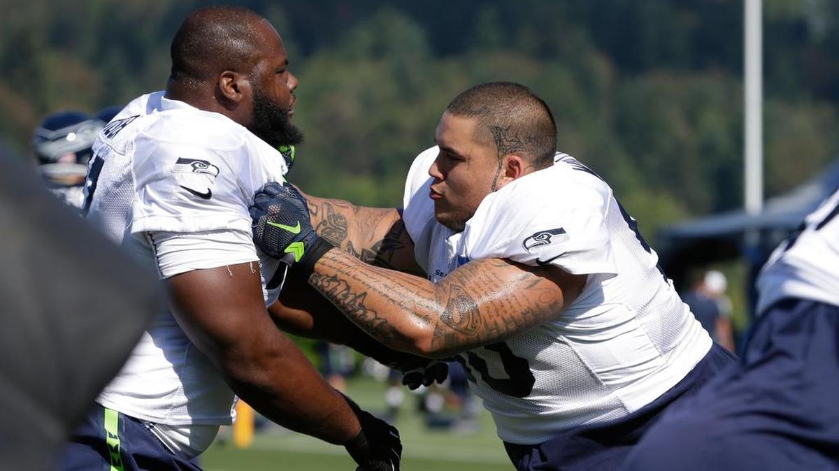 
Seattle Seahawks' Jesse Williams, right, pushes Ahtyba Rubin in a drill at an NFL football training camp Thursday, Aug. 6, 2015, in Renton, Wash. (AP Photo/Elaine Thompson)
