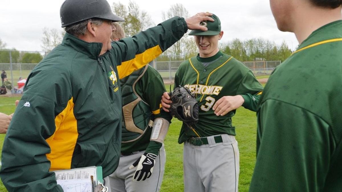 Sehome’s Jake Albert gets a congratulatory hand on the head from coach Gary Hatch after Sehome beat Ferndale 4-2 on April 19, 2014. Hatch announced his retirement after 42 years in 2015.