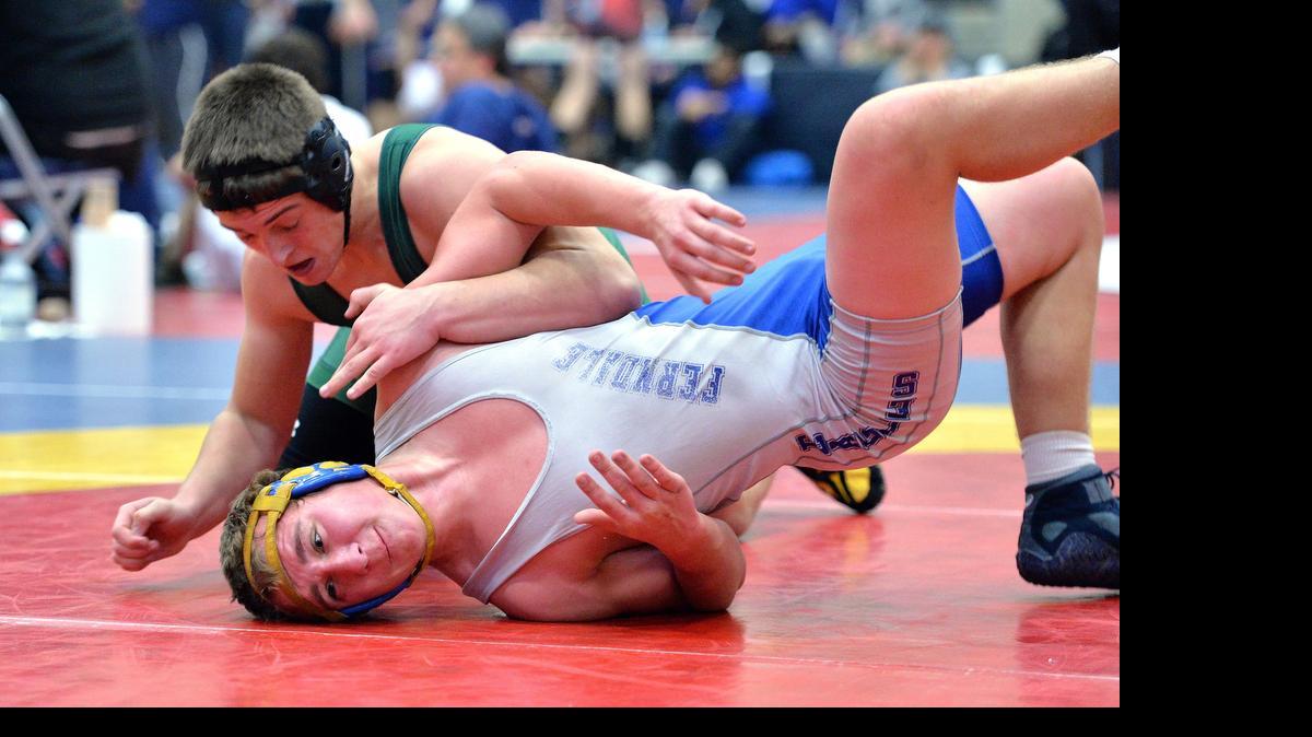 
Ferndale’s Sam Cleary, bottom, attempts an escape from Sehome's Zack Zimmerman, top, at Squalicum High on Saturday, Dec. 21, 2013, in Bellingham.
