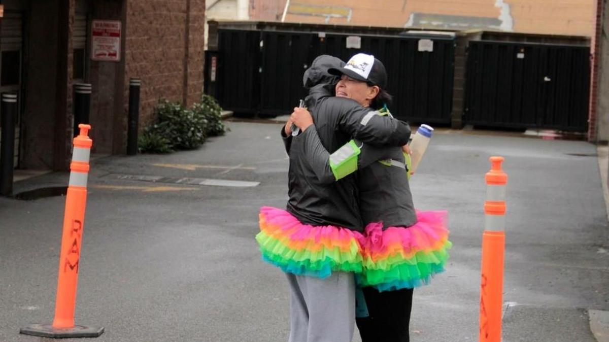 
“I just melted into her arms,” Laura Porter (right) said remembering this moment near the completion of her first marathon. At mile 22 of the 2013 Bellingham Bay Marathon, Reatha Tom embraces Porter in a tearful hug before they continue on to finish the race together.
